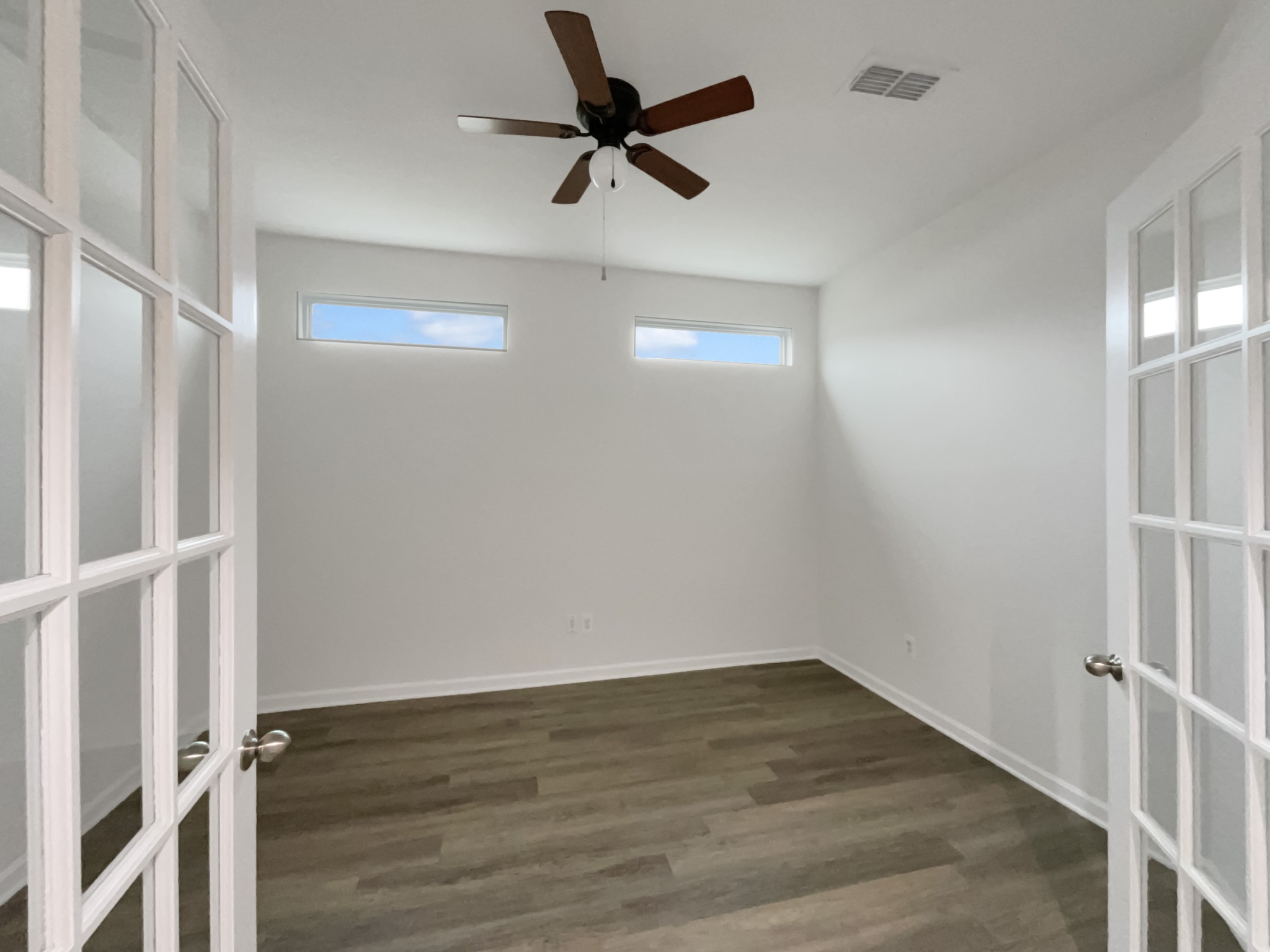203 Fount Hackney Lane Murfreesboro, TN 37129 - Photo 13 of 26 an empty room with wooden floor fan and windows