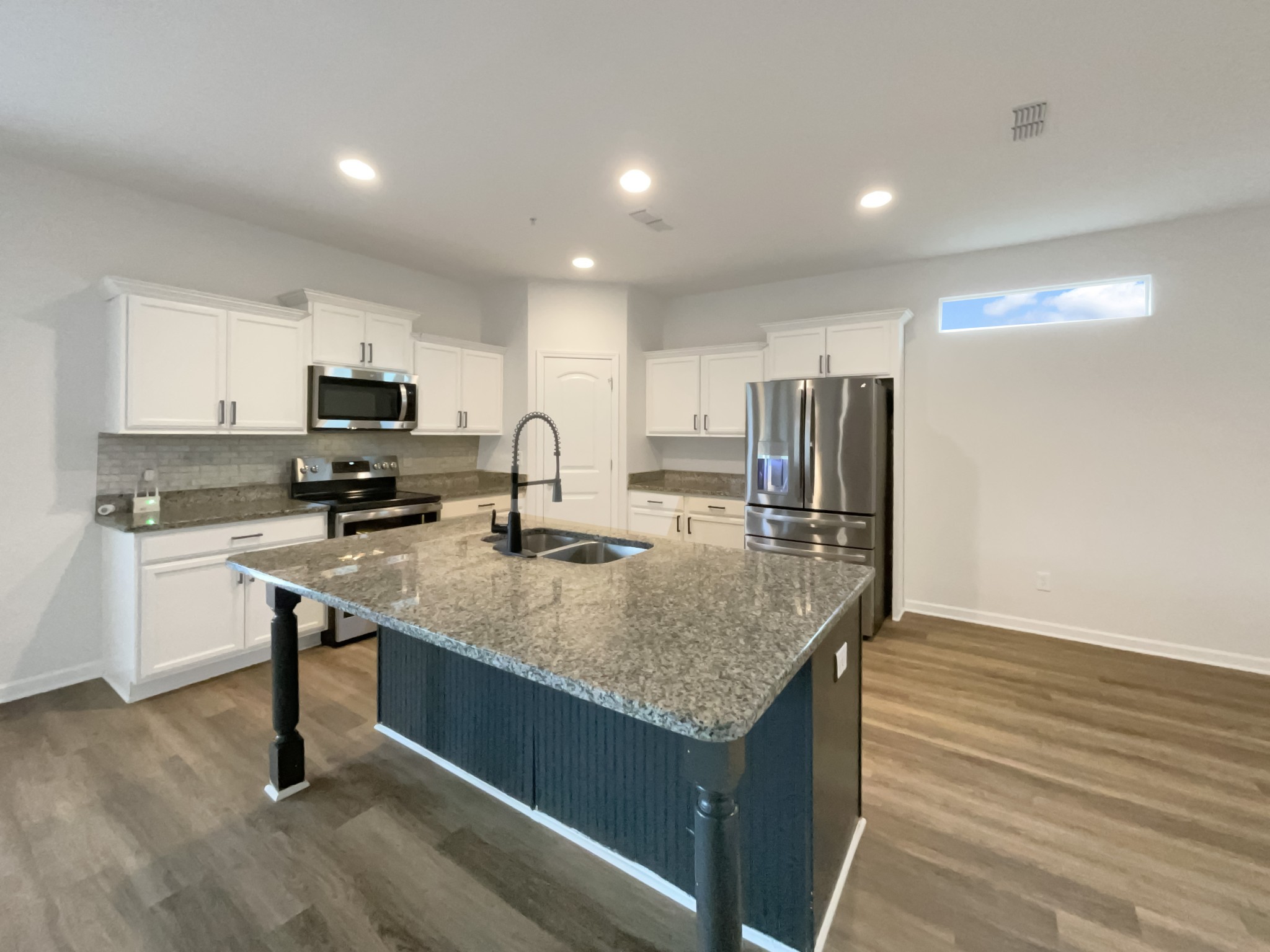 203 Fount Hackney Lane Murfreesboro, TN 37129 - Photo 2 of 26 a kitchen with kitchen island granite countertop a sink stove and refrigerator