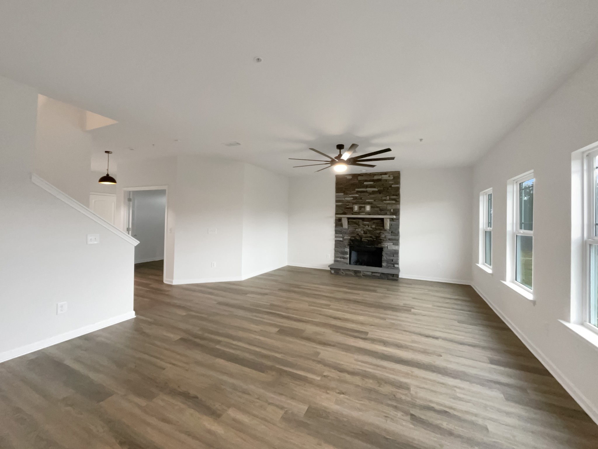 203 Fount Hackney Lane Murfreesboro, TN 37129 - Photo 10 of 26 a view of an empty room with wooden floor fireplace and windows