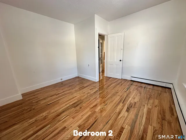 a view of room with wooden floor