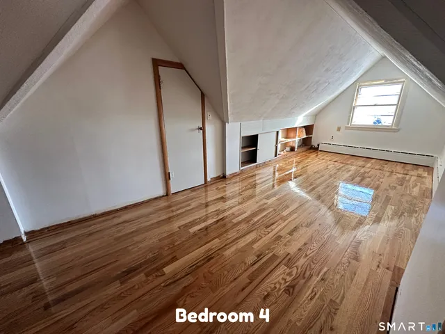 a view of a livingroom with wooden floor and window
