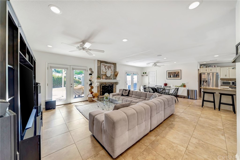 6720 Kurl Way Reseda, CA 91335 - Photo 11 of 40 a living room with furniture a fireplace and a flat screen tv