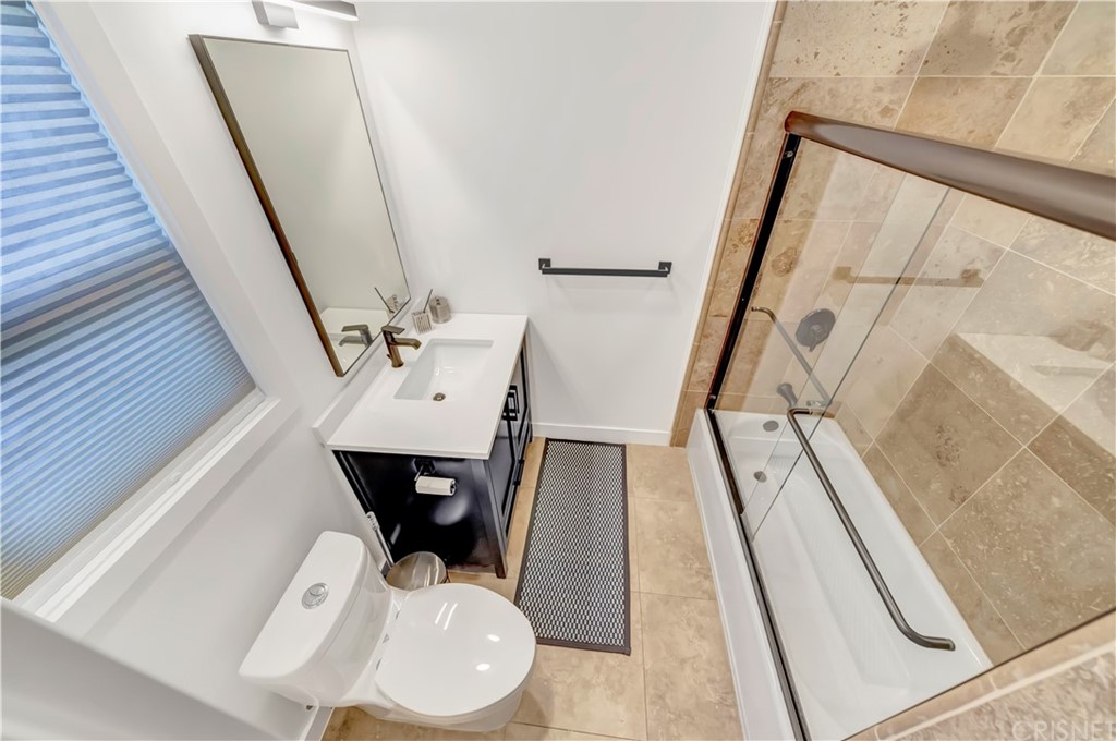 6720 Kurl Way Reseda, CA 91335 - Photo 21 of 40 a bathroom with a sink and mirror with toilet