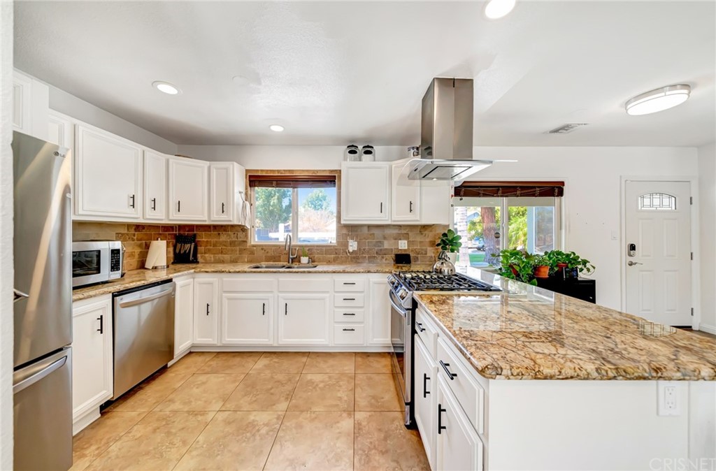 6720 Kurl Way Reseda, CA 91335 - Photo 6 of 40 a kitchen with granite countertop white cabinets and white appliances