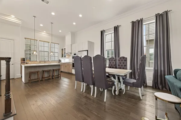 a view of a a dining room with furniture window and wooden floor