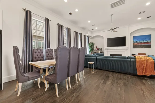 a living room with furniture a flat screen tv and a large window