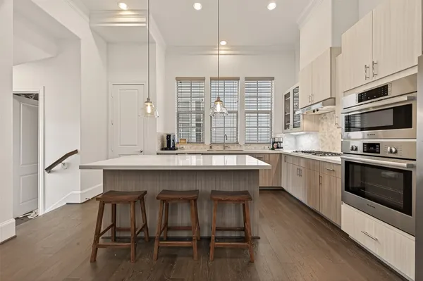 a kitchen with a table chairs sink and cabinets