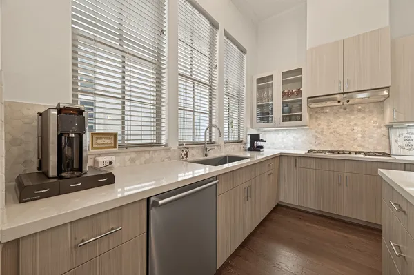 a kitchen with stainless steel appliances granite countertop a sink and a window