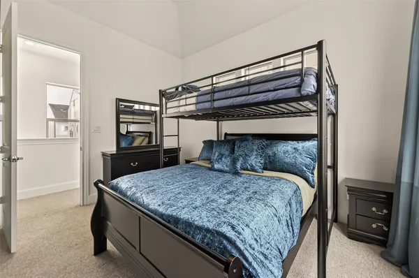 a bed sitting in a bedroom next to a cabinet