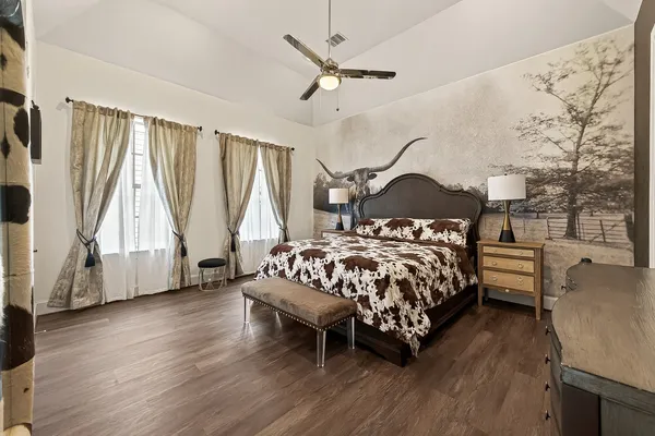 a bedroom with a bed window and a table