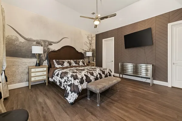 a bedroom with a bed and a flat screen tv