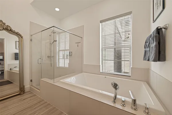 a bathroom with a bathtub and a shower