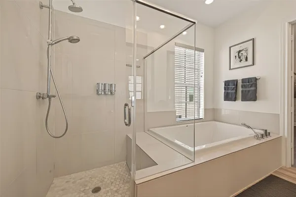 a spacious bathroom with a bath tub and a shower