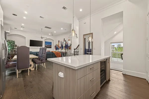 a kitchen that has a lot of cabinets a sink and a wooden floor