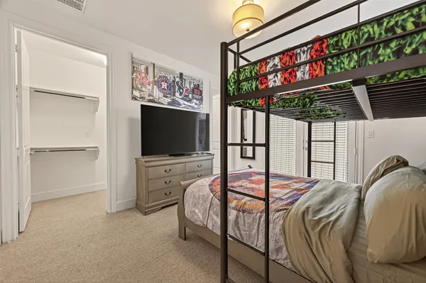 a bedroom with furniture and a flat screen tv