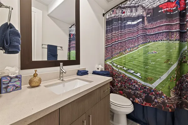 a bathroom with a sink toilet and a mirror