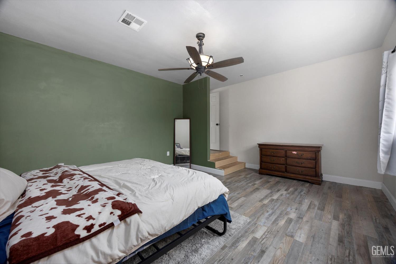 Undisclosed Address Bakersfield, CA 93305 - Photo 15 of 33 a bedroom with a bed and a chandelier