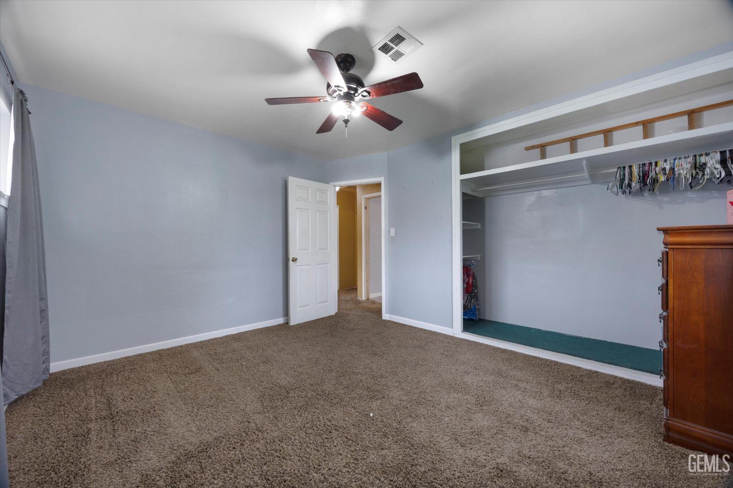 Undisclosed Address Bakersfield, CA 93305 - Photo 19 of 33 a view of an empty room with a chandelier fan