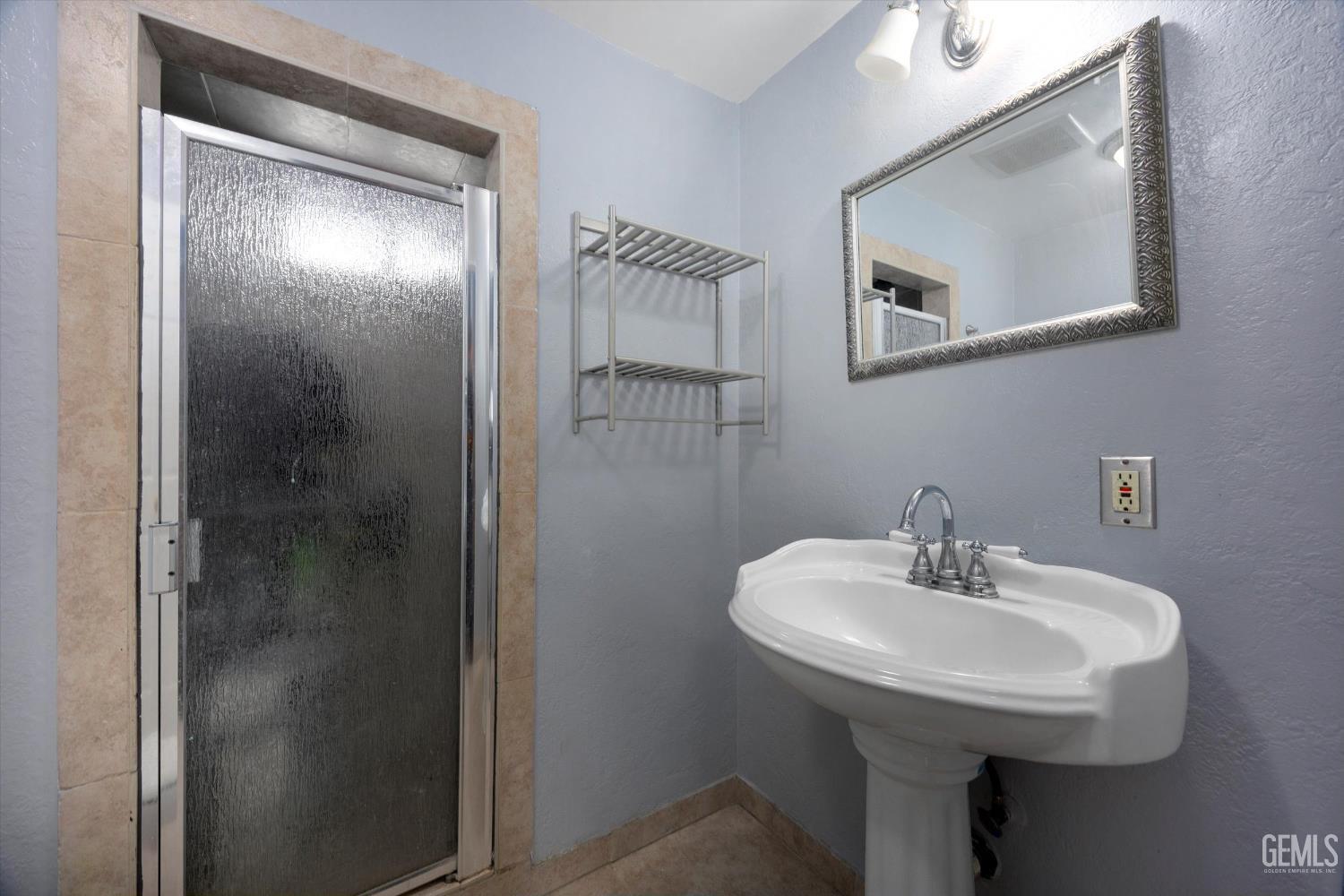 Undisclosed Address Bakersfield, CA 93305 - Photo 24 of 33 a bathroom with a sink and mirror