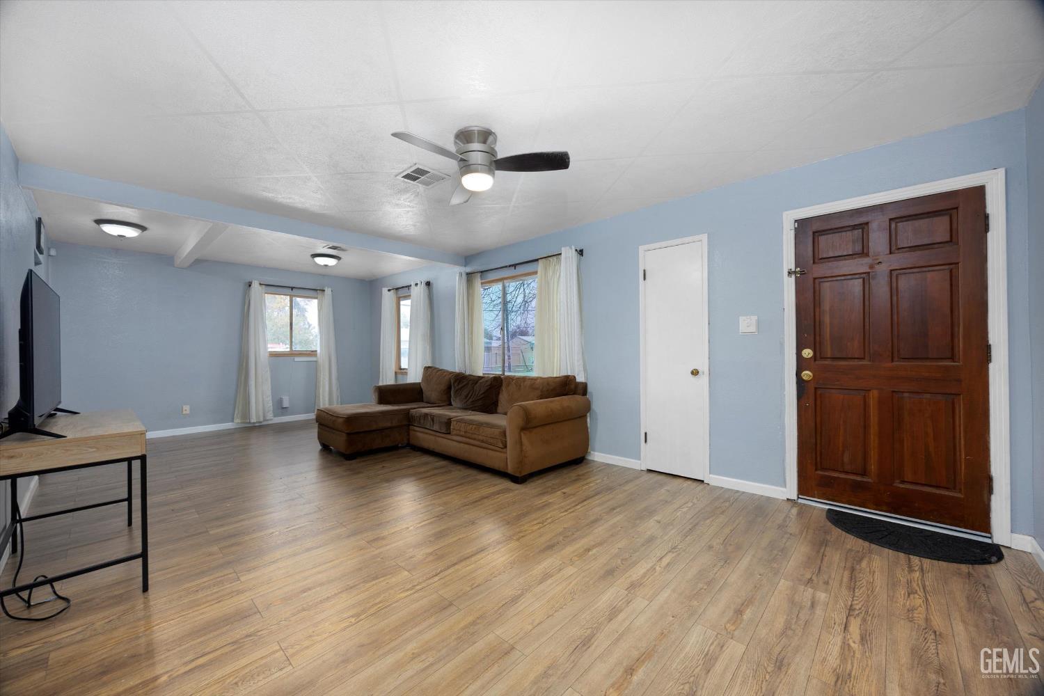 Undisclosed Address Bakersfield, CA 93305 - Photo 3 of 33 a living room with furniture and a wooden floor
