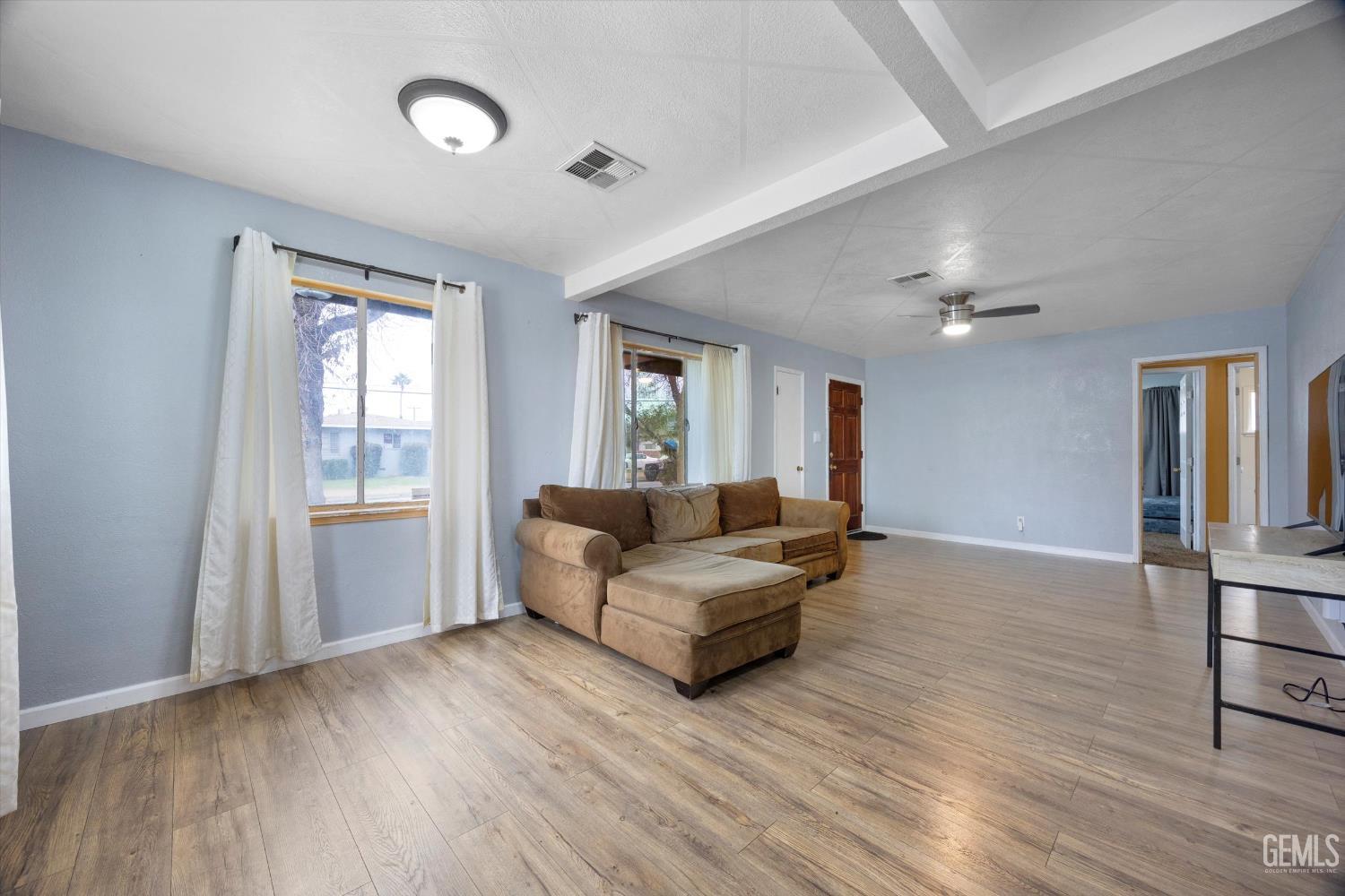 Undisclosed Address Bakersfield, CA 93305 - Photo 4 of 33 a living room with furniture and wooden floor