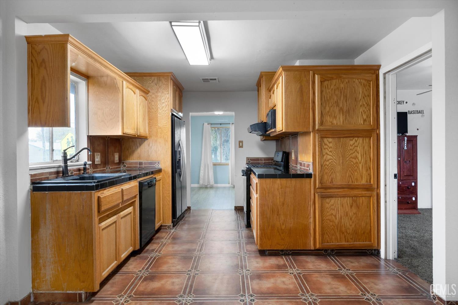 Undisclosed Address Bakersfield, CA 93305 - Photo 9 of 33 a kitchen with stainless steel appliances granite countertop a refrigerator and a stove