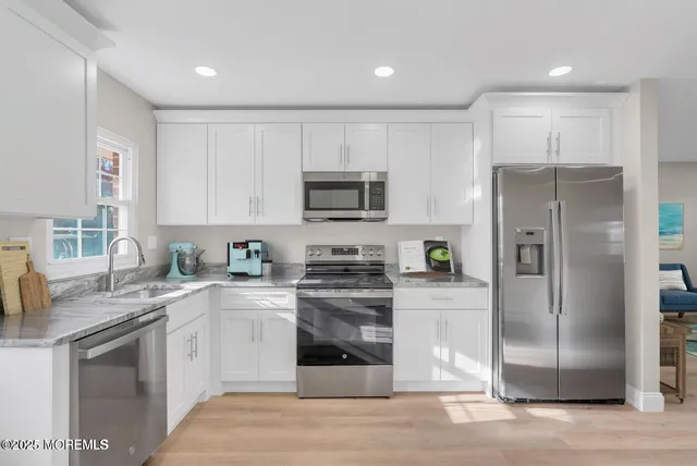 a kitchen with a refrigerator stove and sink