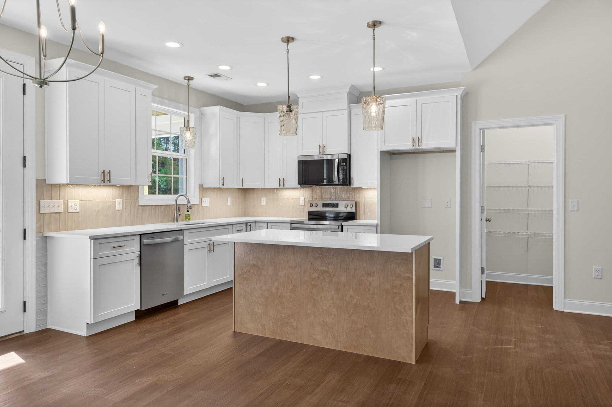 413 Haig Ml Lk Road, Unit 5 Dalton, GA 30720 - Photo 19 of 50 a kitchen with stainless steel appliances granite countertop a sink a stove a refrigerator and island with wooden floor