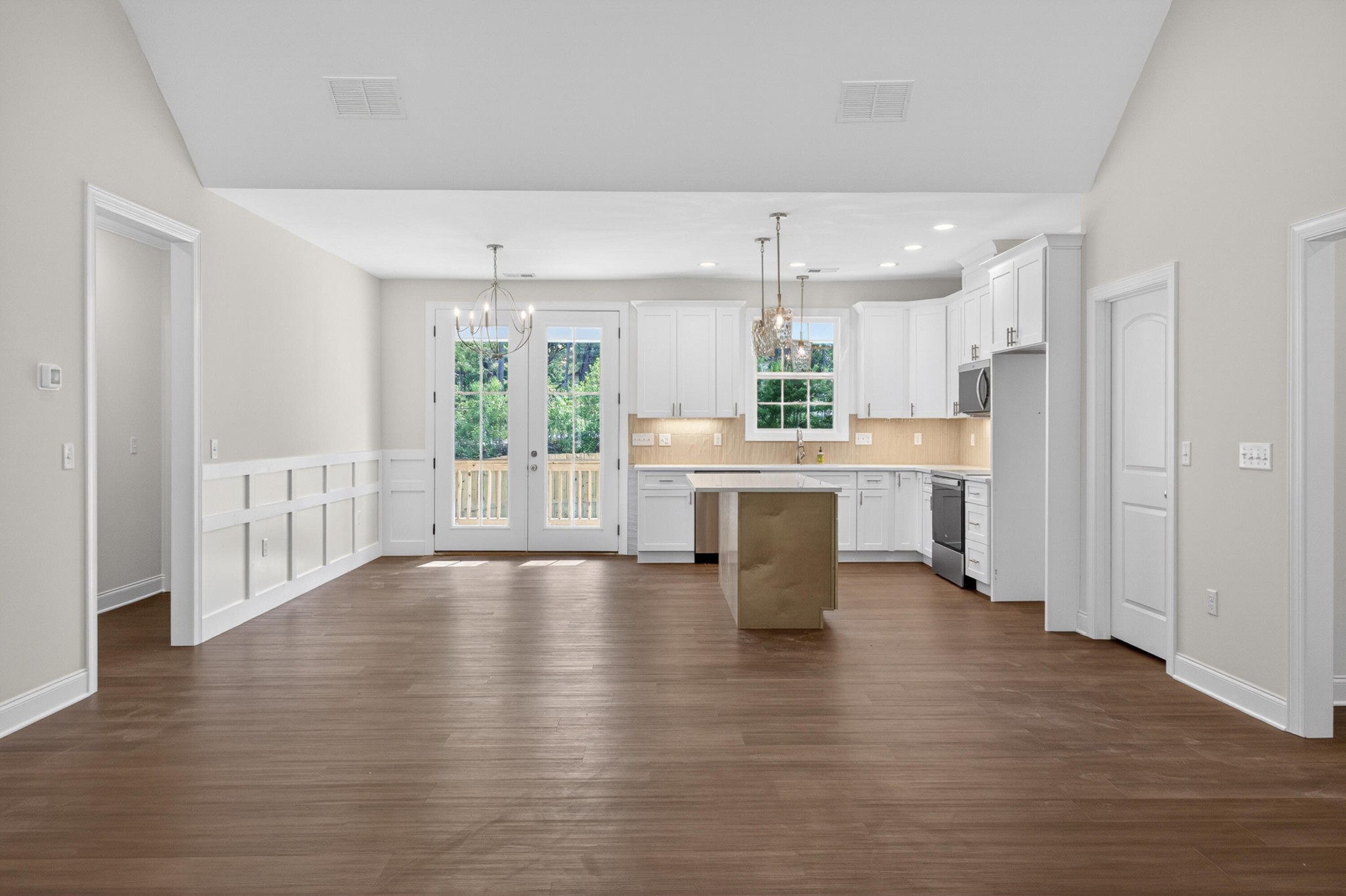 413 Haig Ml Lk Road, Unit 5 Dalton, GA 30720 - Photo 7 of 50 a open kitchen with white cabinets and wooden floor