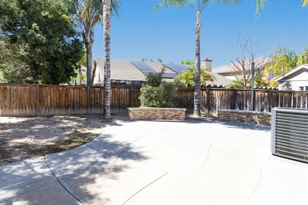 a view of a yard with plants and trees