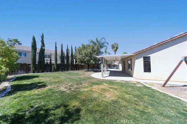 an aerial view of a house with a yard and parking