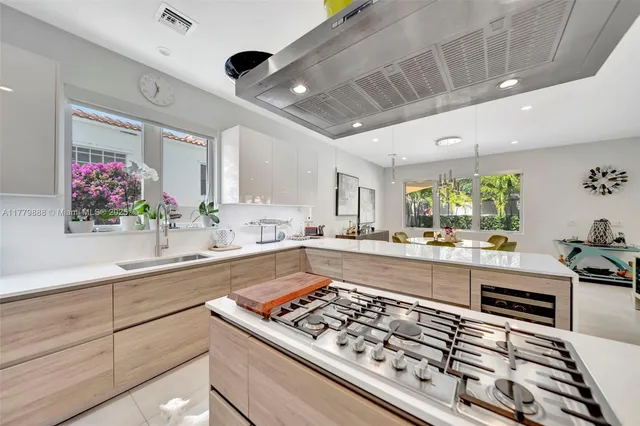a kitchen with stainless steel appliances granite countertop a sink stove and cabinets