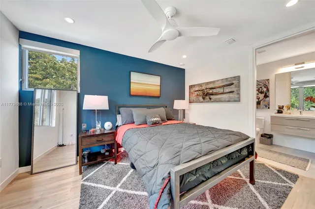 a bedroom with a bed and a view of kitchen