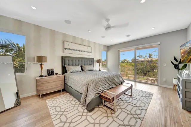 a bedroom with a large bed and a window