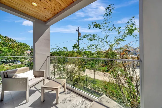 a view of a balcony with lake view and a floor to ceiling window