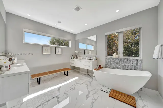 a bathroom with a tub shower and sink