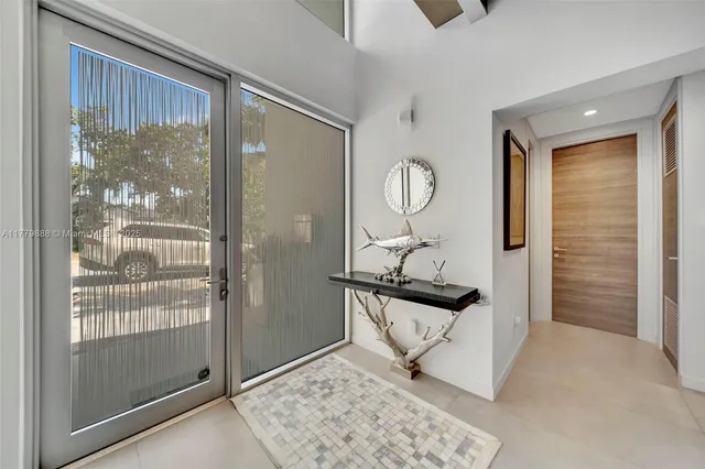 a view of a hallway with wooden floor and windows