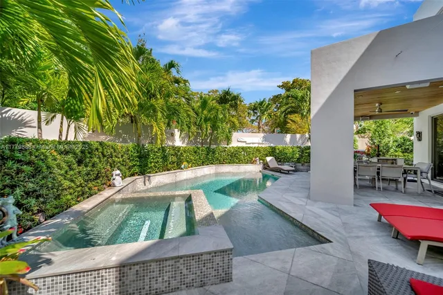 a view of a patio with chair and table and chairs under an umbrella