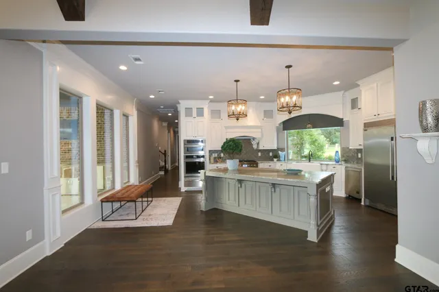 a kitchen with stainless steel appliances granite countertop a stove and a refrigerator