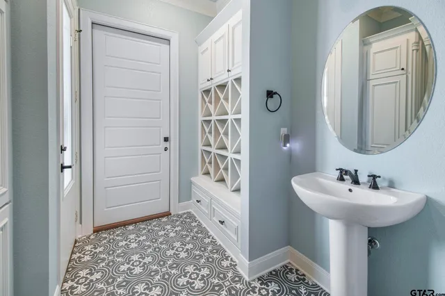 a bathroom with a sink a mirror and a shower