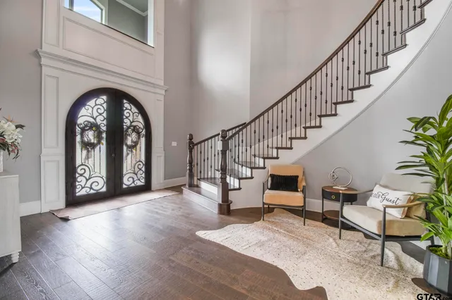 a view of entryway and hall with wooden floor
