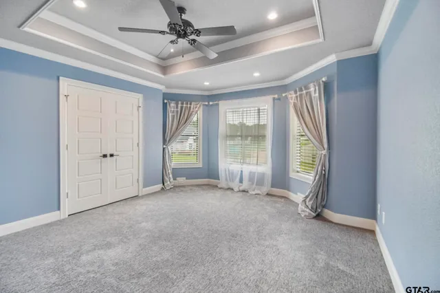 an empty room with windows and closet