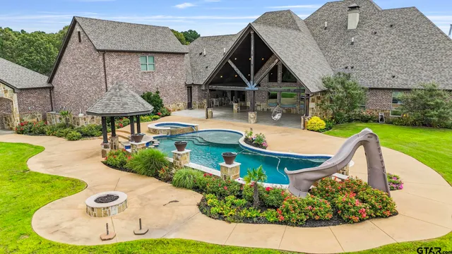 a view of a house with backyard and sitting area
