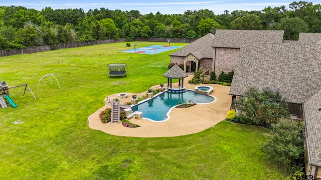 a view of a swimming pool with a yard