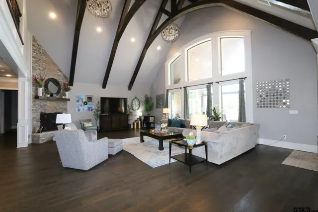 a living room with fireplace furniture and a large window
