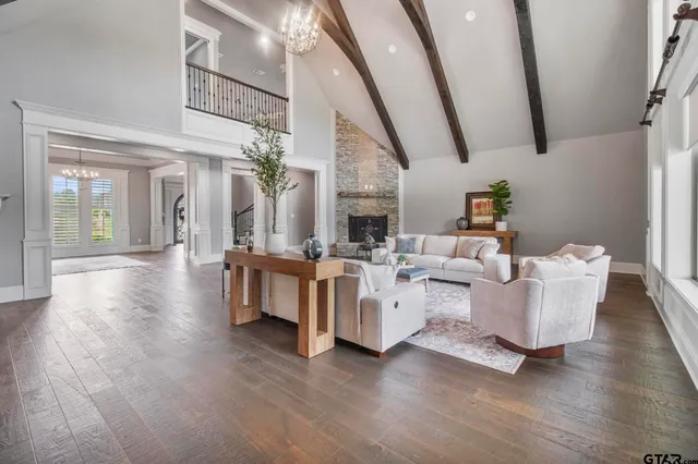 a living room with fireplace furniture and a wooden floor