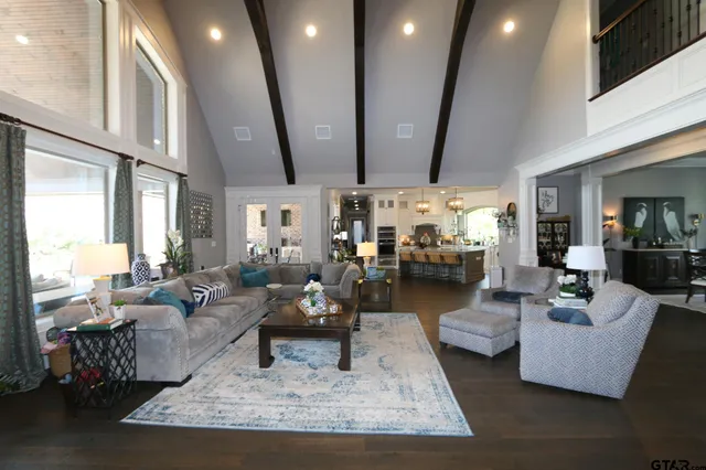 a living room with fireplace furniture and a large window