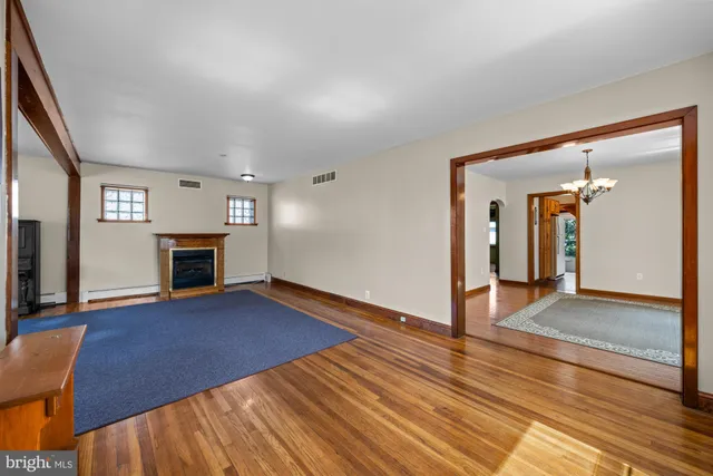 wooden floor in an empty room with a fireplace