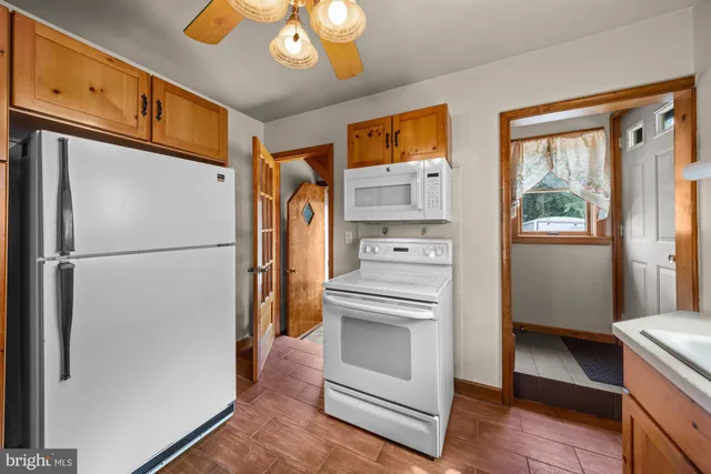 a kitchen with stainless steel appliances a refrigerator sink and cabinets