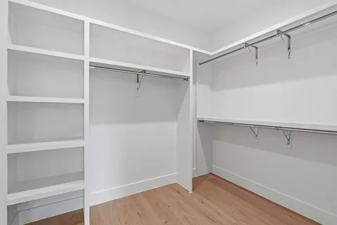 a view of walk in closet with empty racks